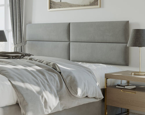 Modern bedroom with a vantpanel gray upholstered headboard, white bedding, and matching bedside lamps.