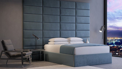 Modern bedroom with a large vantpanel upholstered headboard, Cleopatra layout, and a city view at dusk.