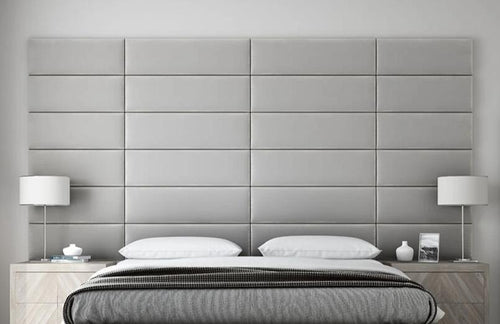 Modern bedroom with large padded headboard and symmetrical bedside lamps, featuring a vantpanel 12 Layout.