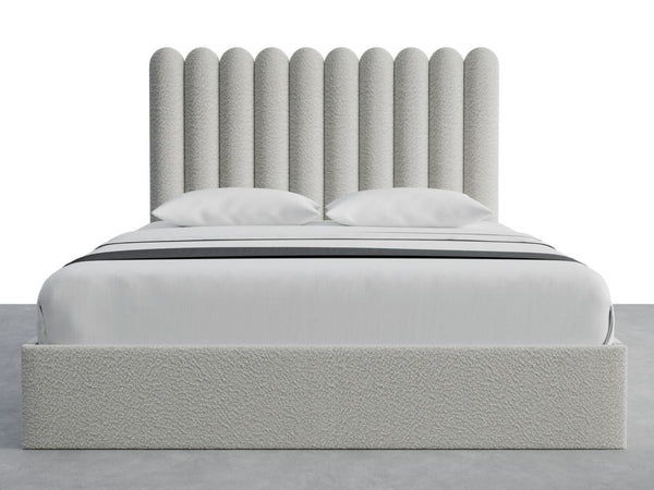 Scalloped Panels Layouts California King | A modern bed with a tall, textured headboard featuring vertical, rounded segments. The bed is neatly made with white linens and two pillows, all set on a simple grey platform. The wall-mounted Scalloped Panels Layouts Queen Size by vantpanel uses SimpleMount installation for added convenience and style.